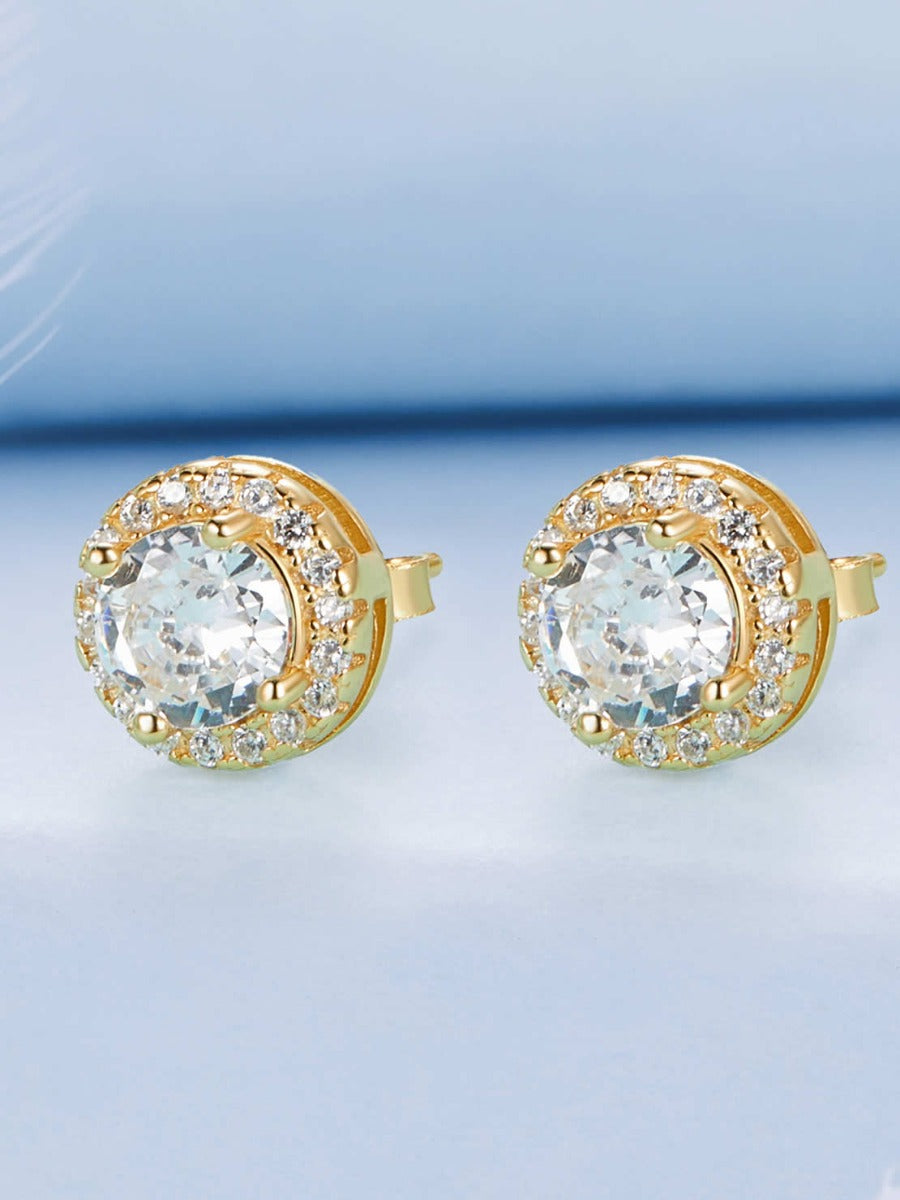 Cercei din argint 925 placat cu aur cu zirconiu pe fundal albastru